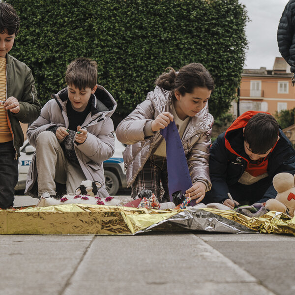 Kids braiding their messages into La Trenza during the presentation in St. Angelo Muxiaro, Sicily Italy 