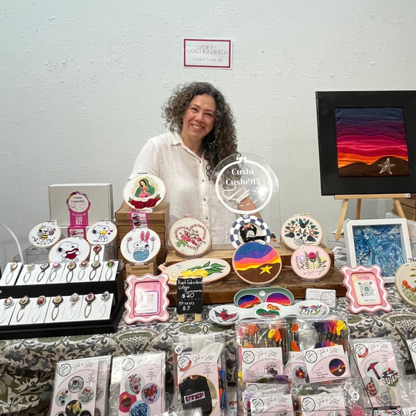 Local artist and vendor CushiCushi getting ready to sell her work at the Las Artistas Spring Art Show at the IMoA