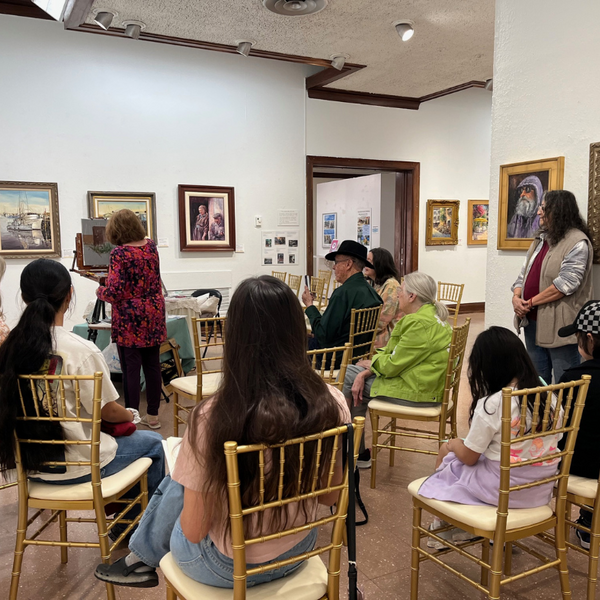 Guests enjoy a special demonstration from Artist Kyrstyna Robbins as she share a bit of her art making process