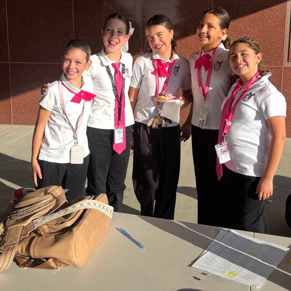 YWA students volunteering for Donuts with Daughters Day