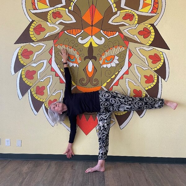 Diane...student now instructor in front of our beautiful studio mural